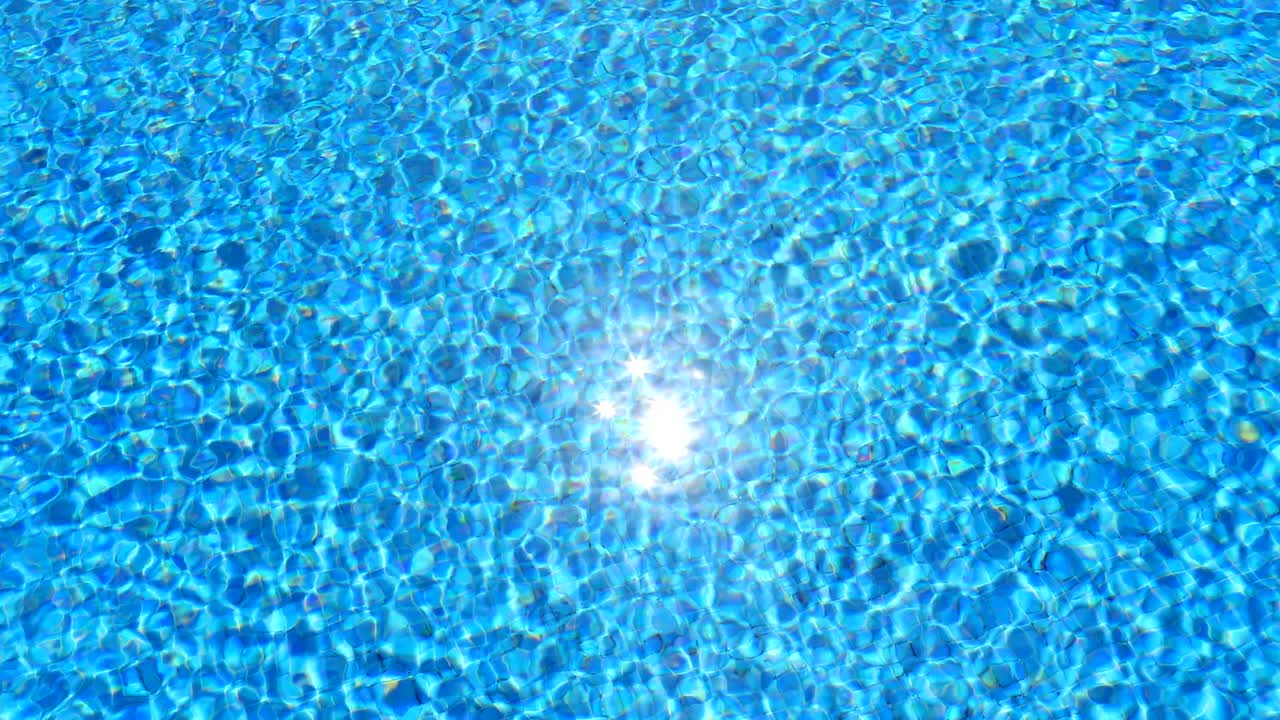 water ripples and sun highlight in swimming pool background