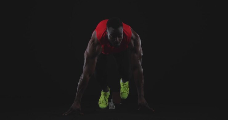 Male runner on starting blocks