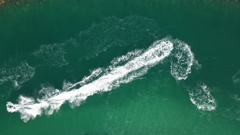 top view of jet-skiing in blue-green crystal clear water of dubai's mamzar beach, arabian sea, top tourist attraction, uae, 4k footage