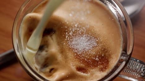 yellow-egg-falling-into-a-bowl-of-flour-in-a-kitchen,-in-slow-motion