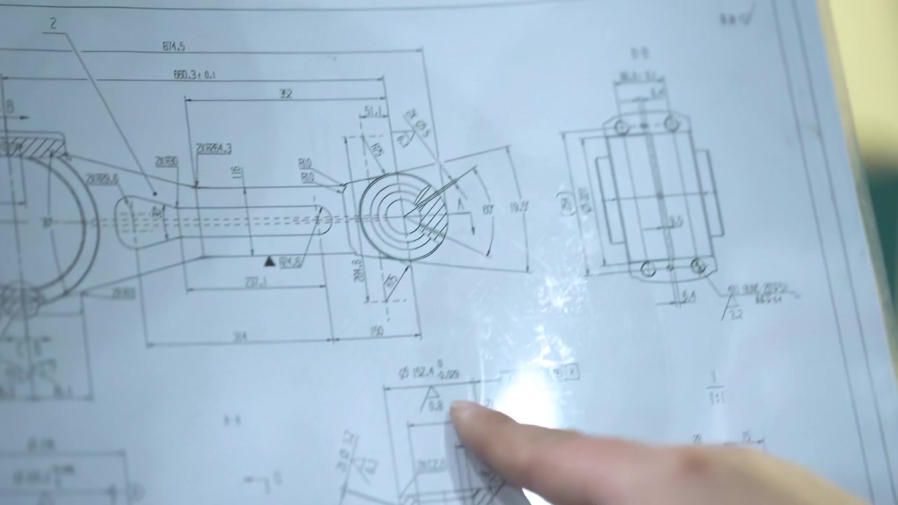 Team of engineers technicians collaborates on project mechanical motor blueprints design technical drawings tools gear components discuss drafts find problem solutions teamwork innovation meeting room