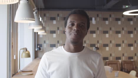 friendly african american young man standing and posing