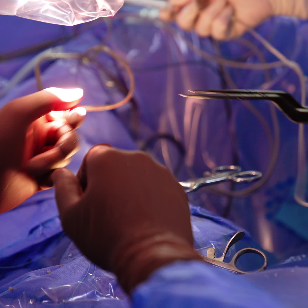 Instruments change during operation. Surgeon in latex gloves passing used tools to the assistant. Close up.