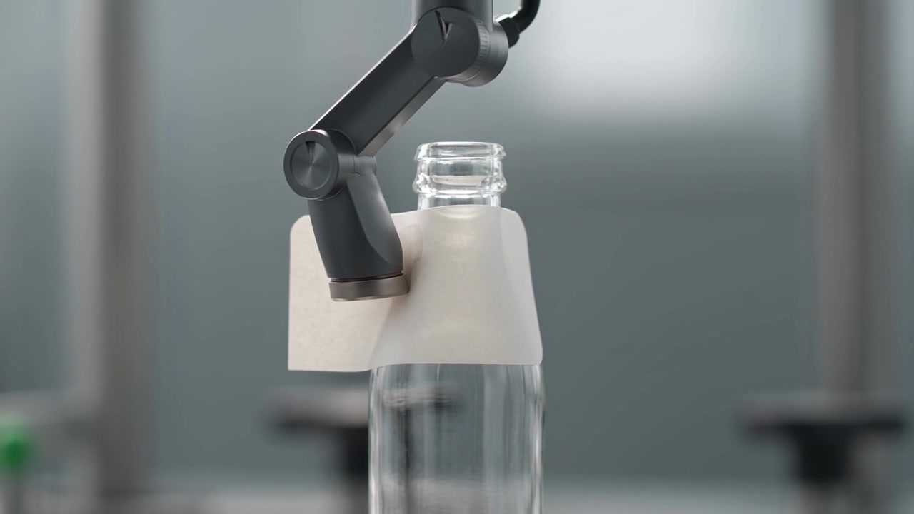 Robotic Arm Applying Label to Glass Bottle in Industrial Setting