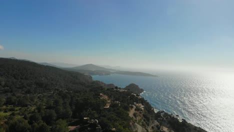 drone rising by a building by the coast on ibiza