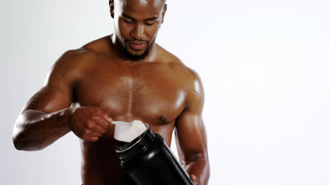 Smiling-muscular-holding-a-protein-bottle