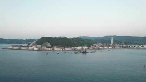 Shore-coastline-aerial-drone-view-at-Wakayama-Japan-oil-tanks-petrol-company-at-sea-island-landscape,-panoramic-view-Japanese-Summer