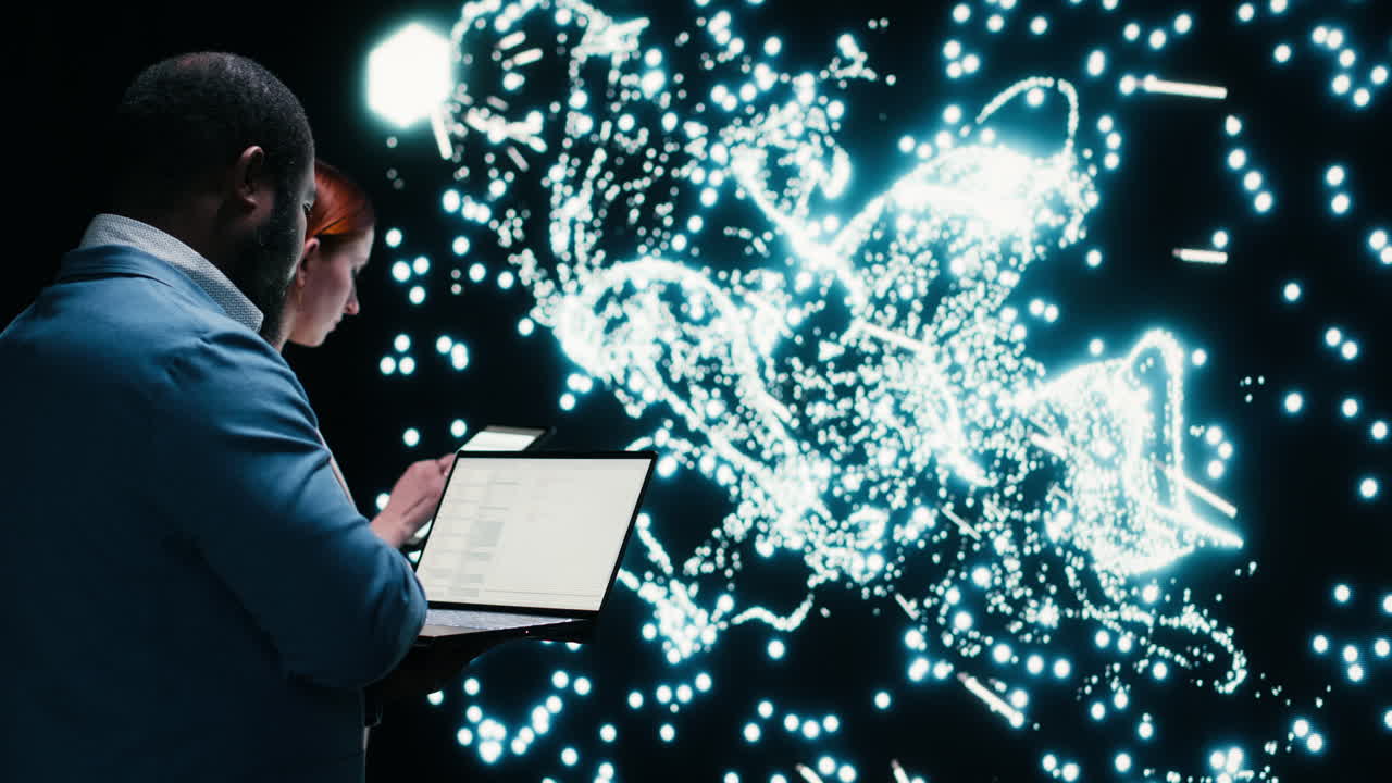 Two Professionals Collaborating with Laptop and Futuristic Data Screen