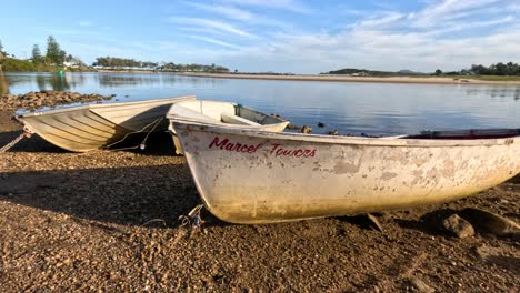 boats resting by a calm lake at different angles