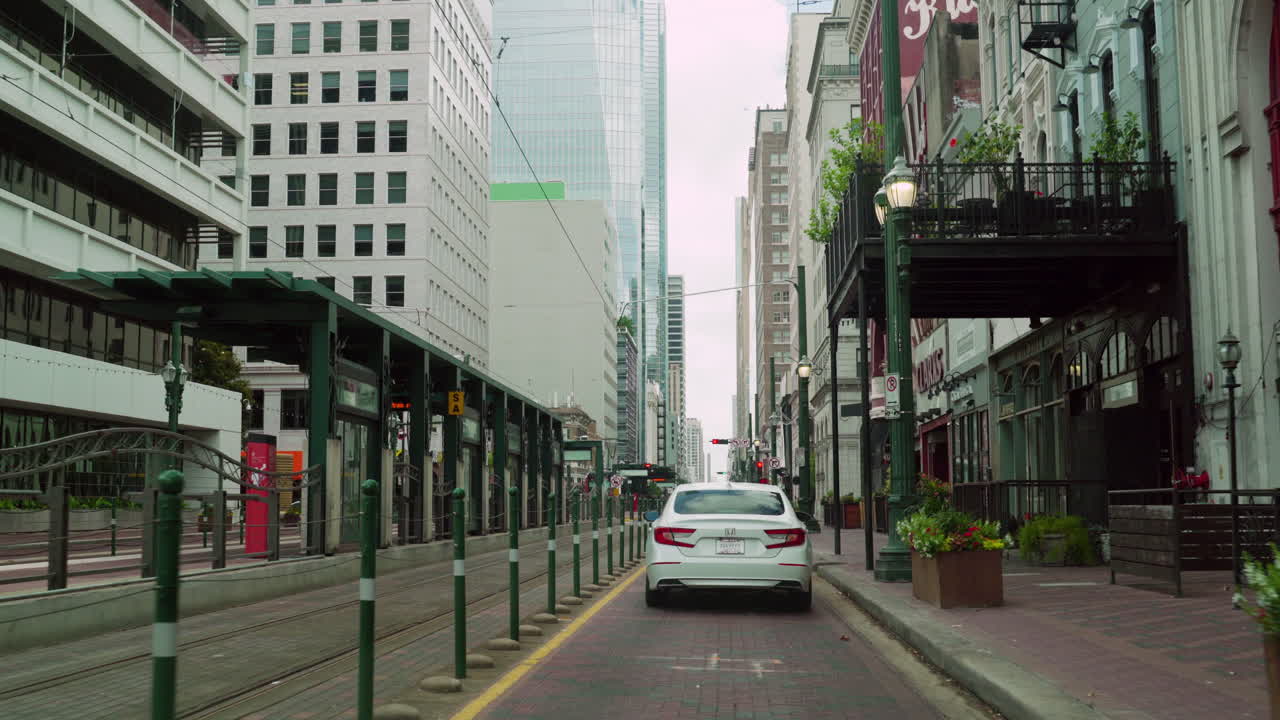 Driving car slowly on Main Street in Downtown of Houston passing Congress Street. Driving pass Preston NB metro station and 990 Congress. Following white car go through the historic Houston areas.