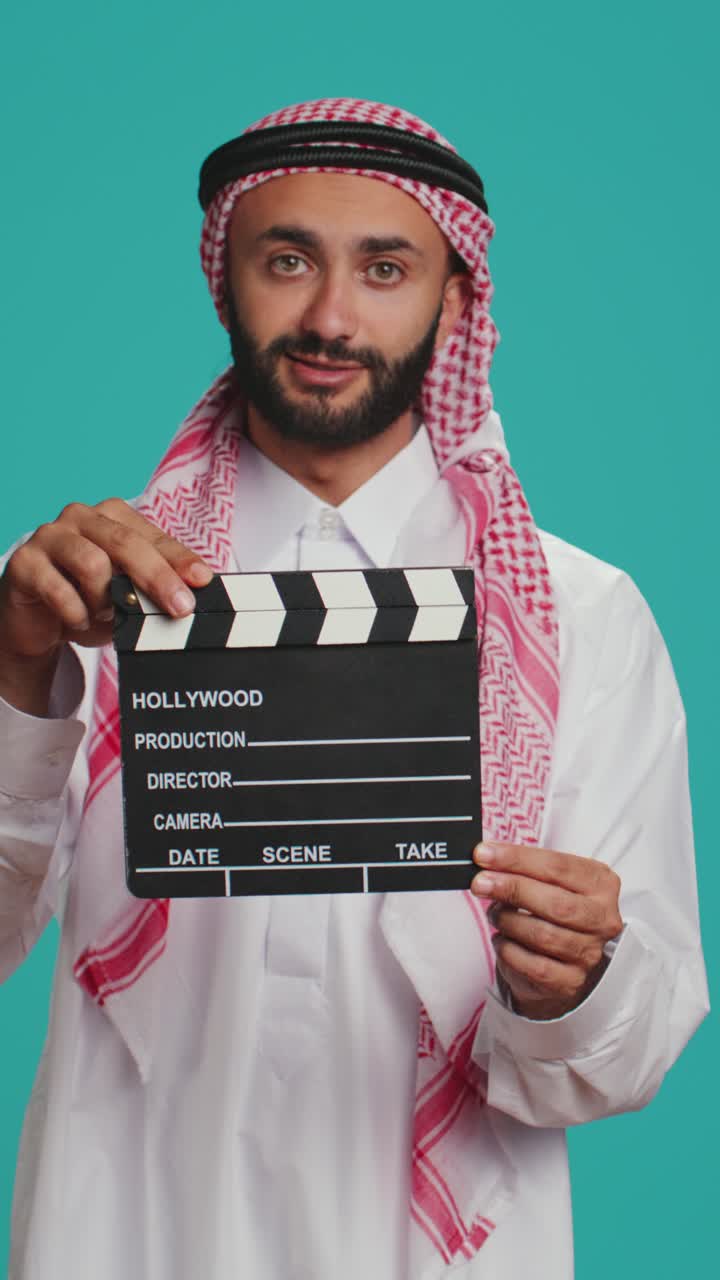 Vertical video Islamic adult with clapperboard