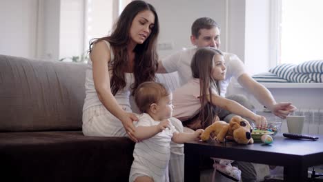 parents and kinds spending time in living room