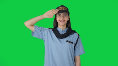 happy indian female security guard saluting green screen