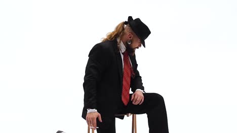 a man in a suit and hat dancing and posing against a white background