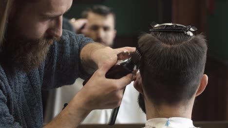 barber trimming client's hair with clippers