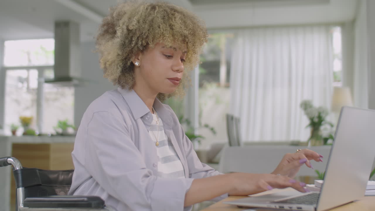 Woman in Wheelchair Working Online on Laptop