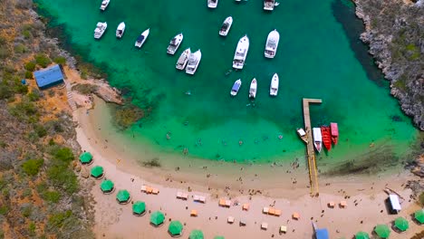 aerial shot of a caribbean beach full of yachts