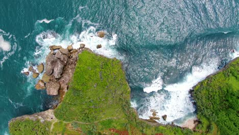 Top-down-aerial-waves-of-Indian-Ocean-splash-on-cliffs-of-Krakal-coast-Indonesia