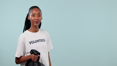 Trash-bag,-volunteer-and-happy-black-woman-point