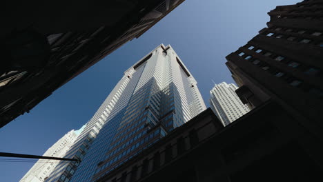 looking up at a skyscraper in a city