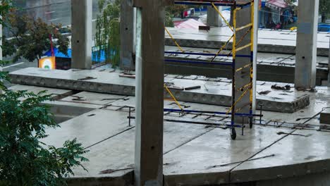 construction site in the rain. the builders left the workplace due to bad weather. concrete slabs and precast reinforced concrete piles are flooded with water. the workers went on a forced break