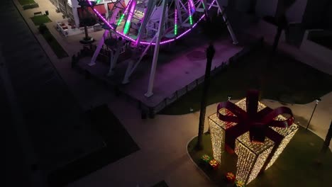 reverse reveal of a lighted ferris wheel