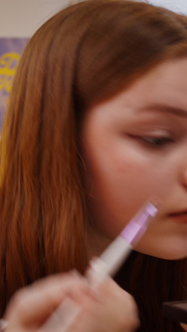 Applying makeup to a woman