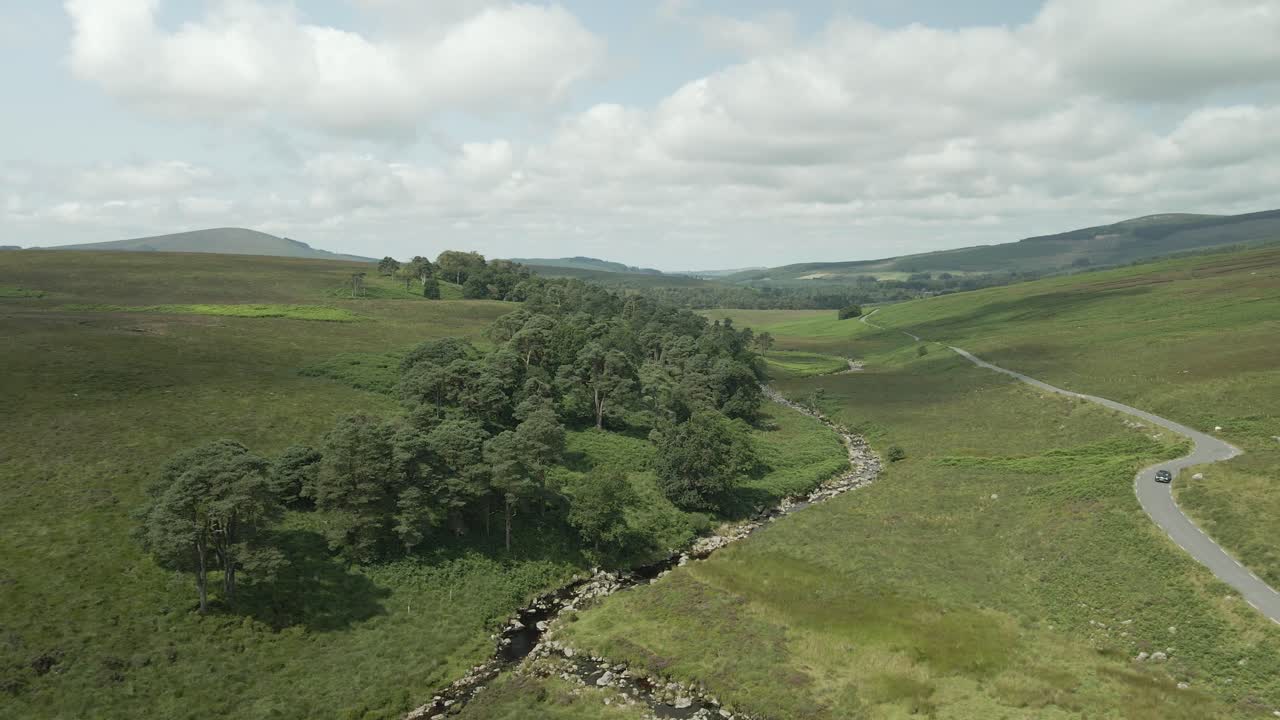 Wicklow, Ireland - A Sweeping View of a Lush Green Landscape With Mountains in the Background - Drone Flying Forward