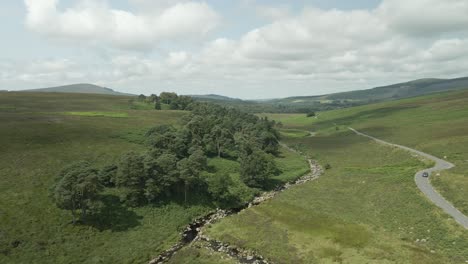wicklow, ireland - a sweeping view of a lush green landscape with mountains in the background - drone flying forward