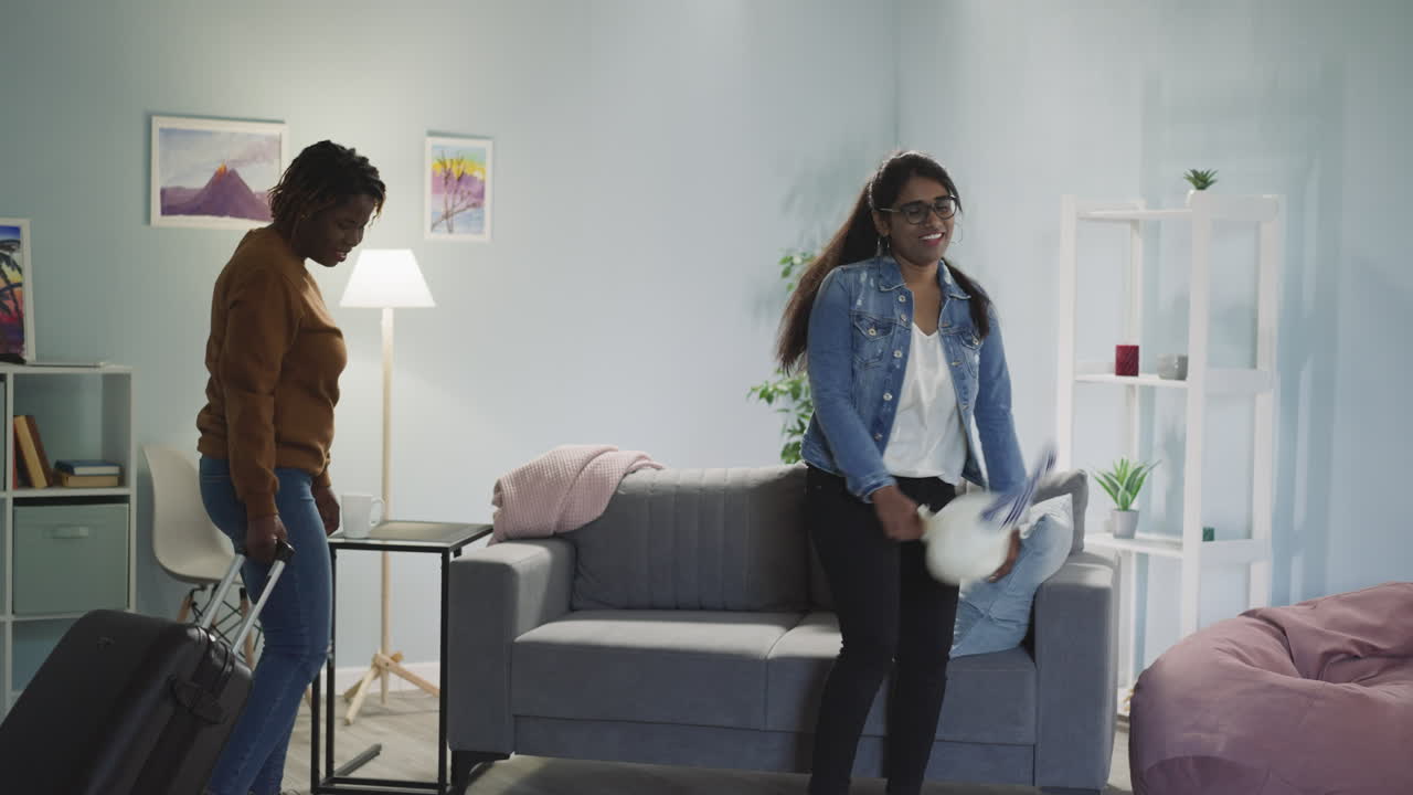 Tired ladies with big suitcase come home after long flight