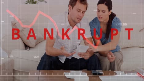 bankrupt text and red graph moving against couple checking their bills