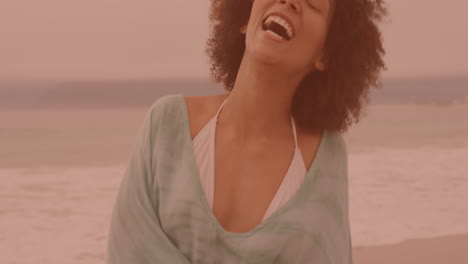 portrait of african american woman smiling and enjoying at the beach