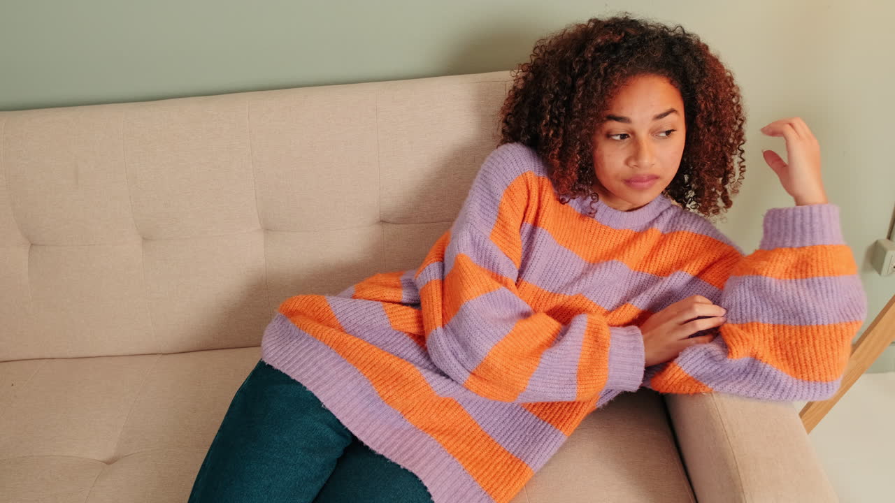 Pensive Young Woman Resting on Couch