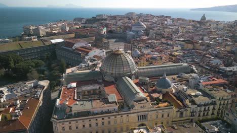 amazing drone view above galleria umberto i, aerial pullback reveals major tourist destination in naples, italy