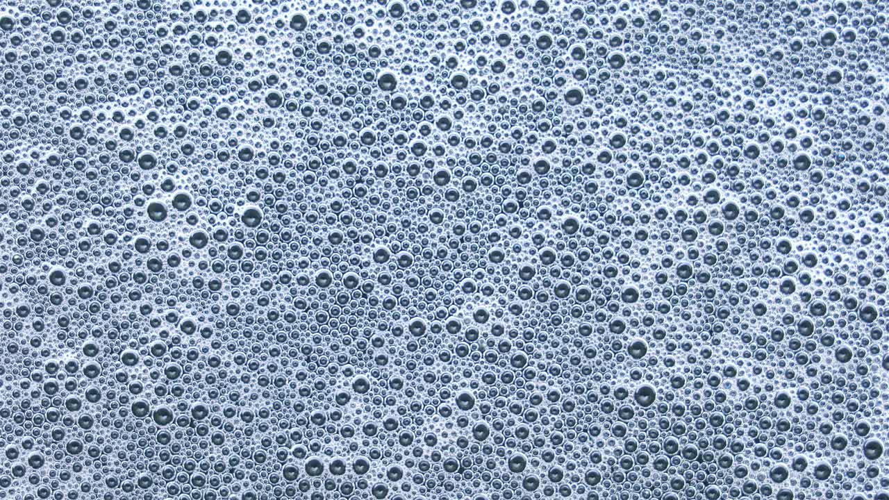 escena de primer plano de burbujas de detergente flotando en la superficie del agua