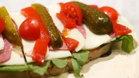 appetizer sandwiches with cheese, meat, and vegetables