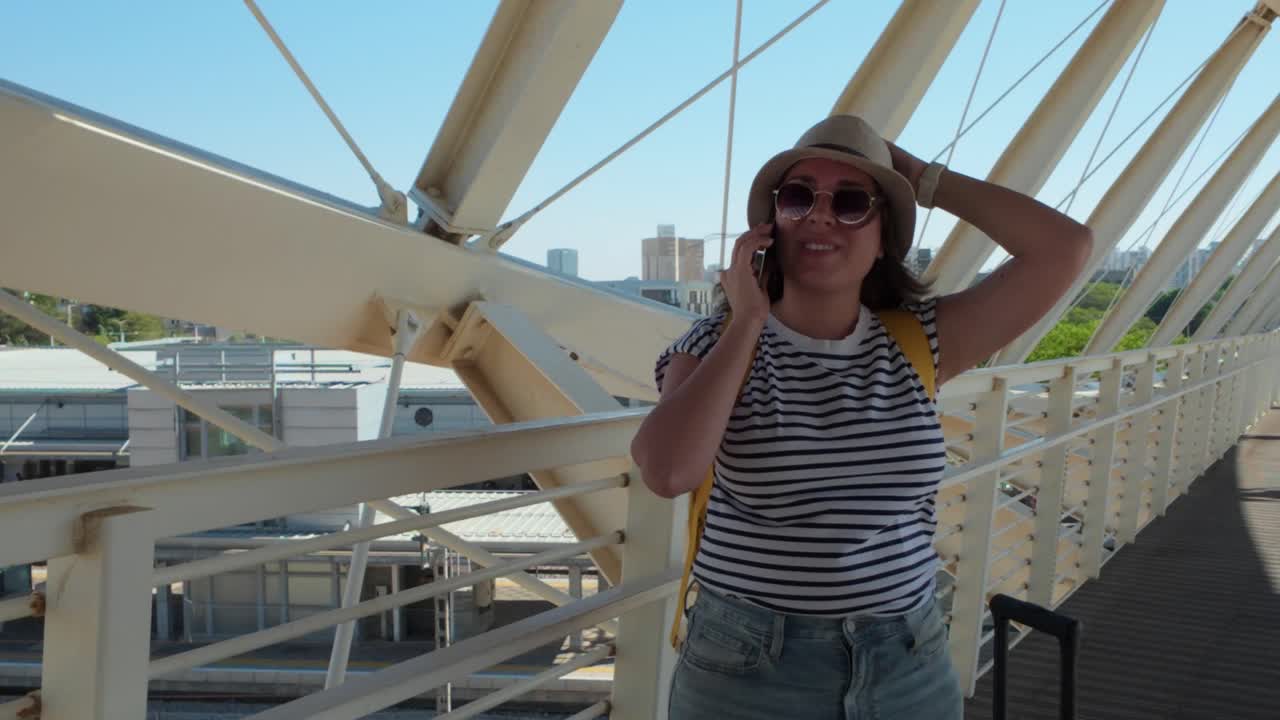 Woman Talking on Phone at Train Station Bridge