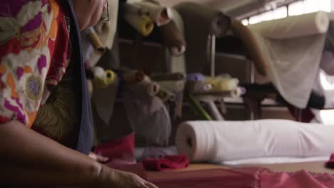 mixed race woman working at a hat factory