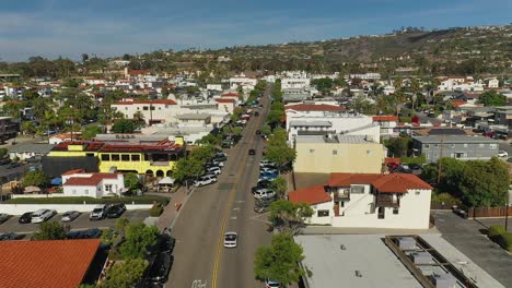 Aerial-follow-of-a-car-up-Del-Mar-in-San-Clemente,-California