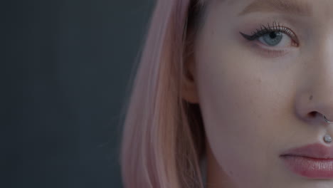 close-up portrait of a woman with pink hair and piercings