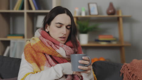 woman feeling ill on sofa