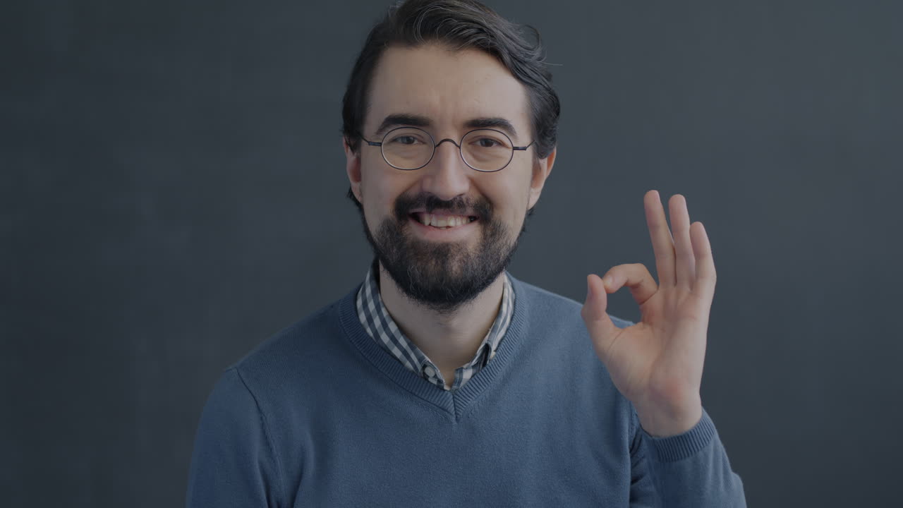 Man Smiling and Making an Ok Sign