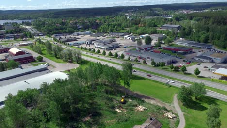 Flying-Over-Construction-Site-Towards-Industrial-Area,-Sweden,-Aerial