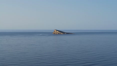 lone mediterranean deserted island off benidorm seen from above 4k