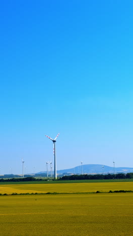 wind turbines against a clear blue sky. wind turbines stand tall in a flat landscape under a vibrant blue sky, showcasing renewable energy in action