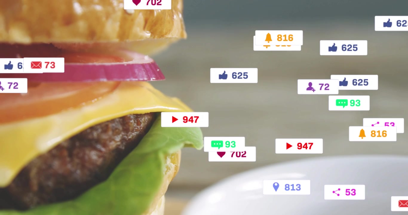 Vertical video: Burger moving as social likes making badges over cup, receding revealing food buzz