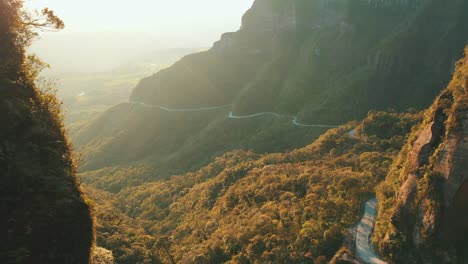 Amazing-road-inside-a-tropical-rainforest-mountain-at-sunrise-aerial-view,-Serra-Do-Corvo-Branco,-Grão-Pará,-Santa-Catarina,-Brazil