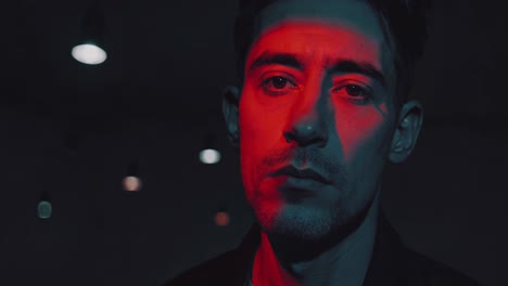 close-up portrait of a man under red light