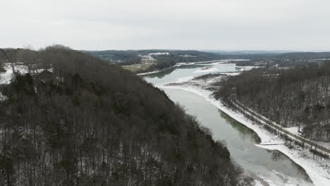 fading nature - slighty frozen lake and gray, deciduous forest