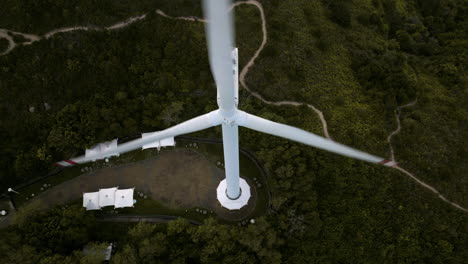 Large-Wind-Turbine-Spinning,-Green-Energy,-Lamma-Island,-Hong-Kong,-City-Skyline,-Ocean,-Cinematic-Aerial-Establishing-Shot,-Flying-Backwards
